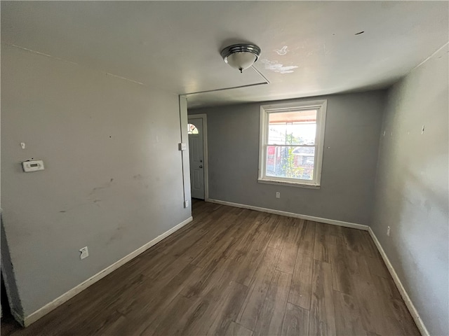 empty room with dark hardwood / wood-style floors