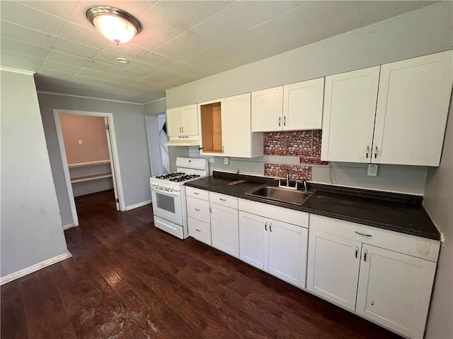 2323 Patterson Ave, Swissvale, PA 15218 - kitchen featuring white gas range oven, a sink, under cabinet range hood, dark countertops, and dark wood finished floors
