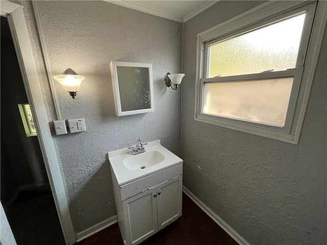 2323 Patterson Ave, Swissvale, PA 15218 - bathroom featuring vanity, baseboards, ornamental molding, wood finished floors, and a textured wall