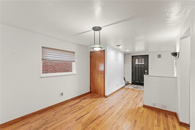 unfurnished room featuring light hardwood / wood-style flooring and a wealth of natural light