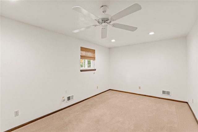 unfurnished room featuring ceiling fan and light colored carpet