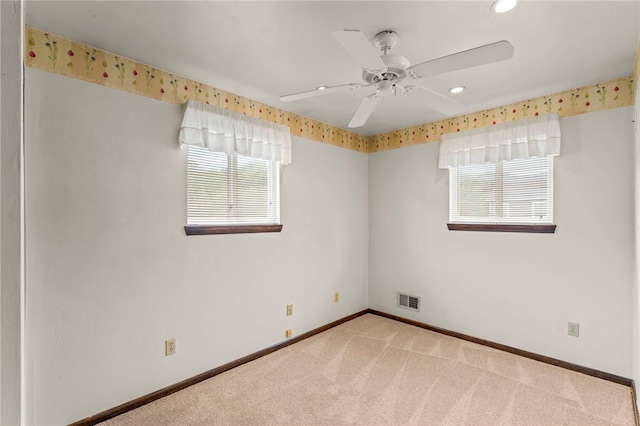 unfurnished room with light carpet, plenty of natural light, and ceiling fan