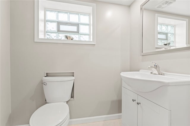 bathroom with tile patterned flooring, vanity, and toilet