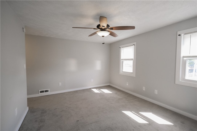 empty room featuring carpet floors, a textured ceiling, and ceiling fan