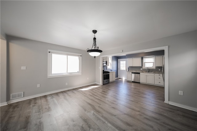 unfurnished living room with dark hardwood / wood-style floors and sink