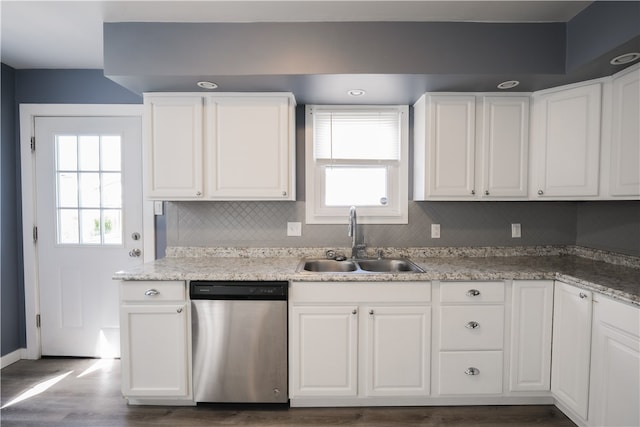 kitchen featuring hardwood / wood-style floors, stainless steel dishwasher, white cabinetry, and sink