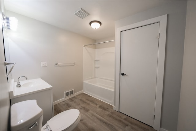 full bathroom with bathtub / shower combination, hardwood / wood-style floors, vanity, and toilet