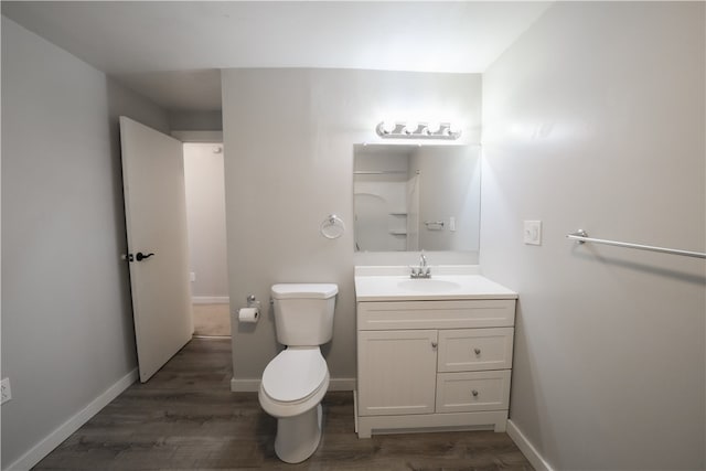 bathroom with vanity, hardwood / wood-style floors, and toilet