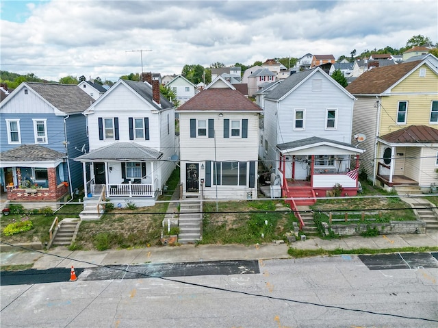 townhome / multi-family property featuring covered porch