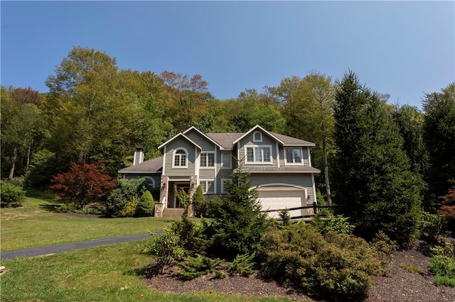 view of front of house featuring a front yard and a garage