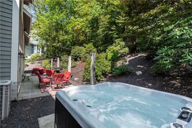 view of patio with central AC unit and a hot tub