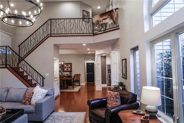 living room with dark wood-type flooring and a towering ceiling