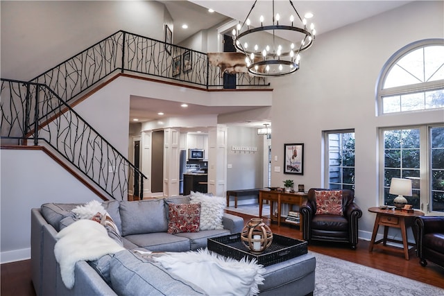 living room featuring wood-type flooring and a towering ceiling