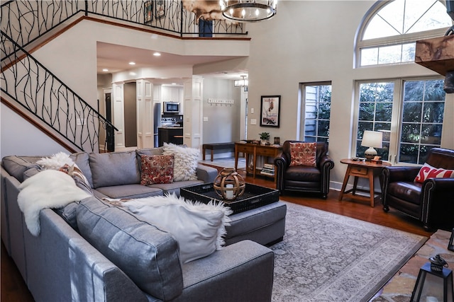 living room featuring a high ceiling and wood-type flooring