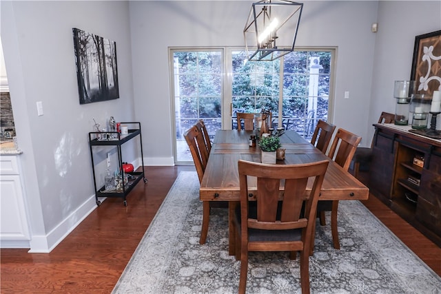 dining room with a notable chandelier and dark wood-type flooring