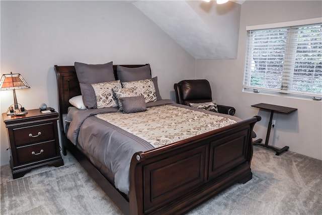 carpeted bedroom featuring lofted ceiling