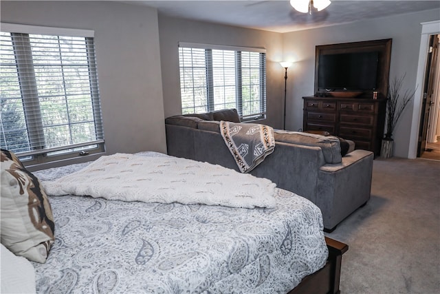 bedroom featuring ceiling fan, carpet, and multiple windows