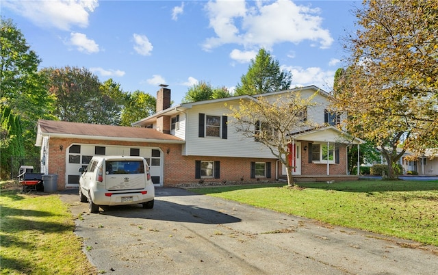 split level home with a garage and a front lawn