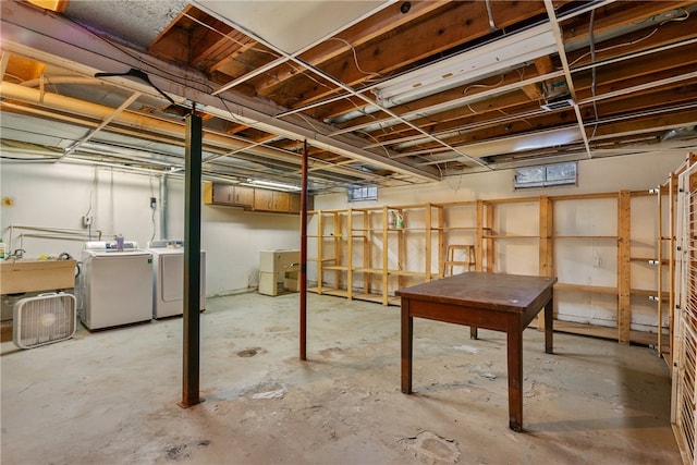 basement featuring independent washer and dryer and sink