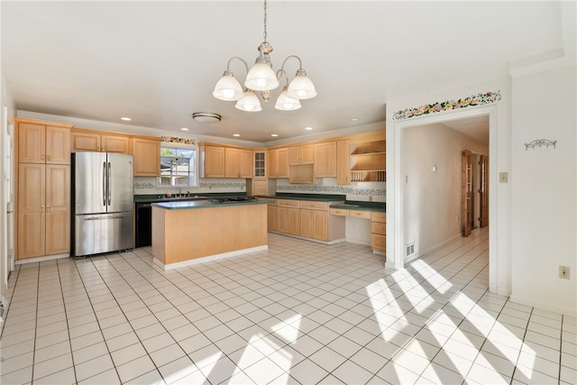 kitchen with light tile patterned flooring, stainless steel refrigerator, pendant lighting, gas cooktop, and a notable chandelier