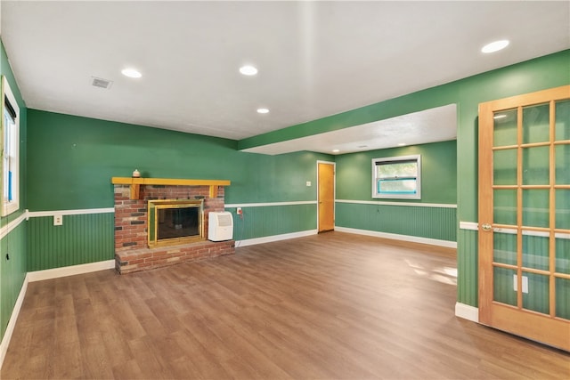 unfurnished living room with a fireplace and hardwood / wood-style flooring