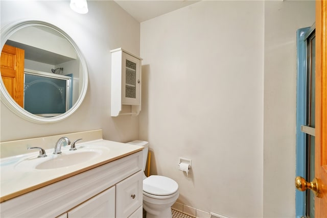 bathroom featuring vanity, toilet, and tile patterned floors