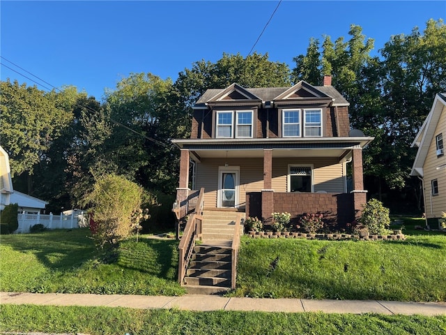 craftsman house featuring covered porch and a front yard