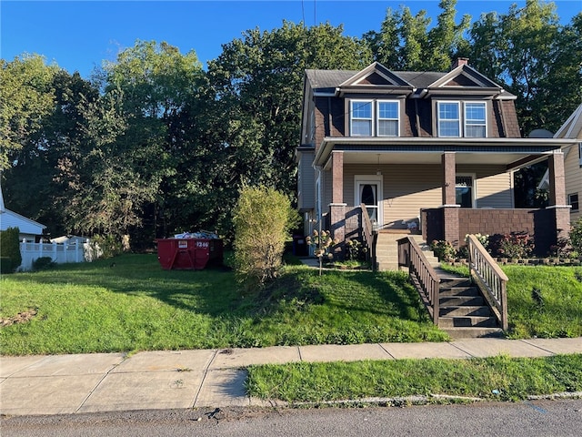 view of front of home with a front lawn and covered porch