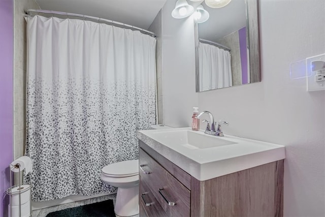 bathroom with walk in shower, vanity, toilet, and tile patterned floors