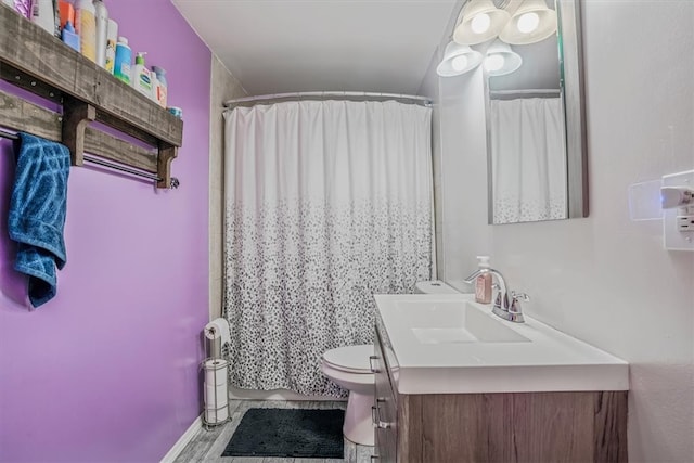 bathroom featuring vanity, toilet, and a shower with curtain