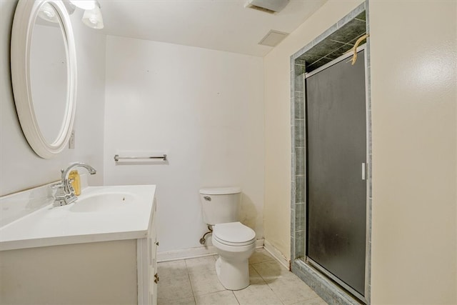 bathroom with vanity, toilet, a shower with door, and tile patterned floors