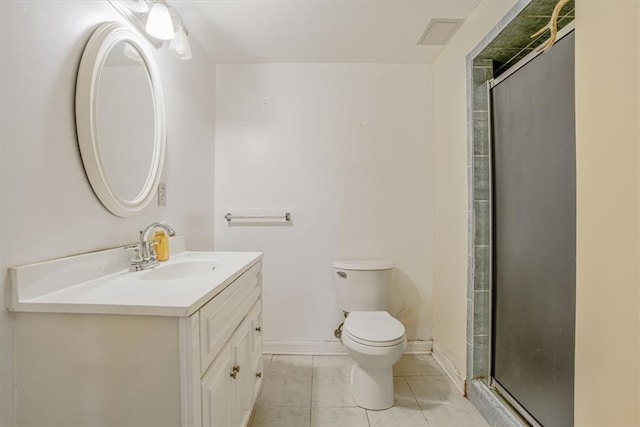 bathroom featuring vanity, a shower with shower door, toilet, and tile patterned floors