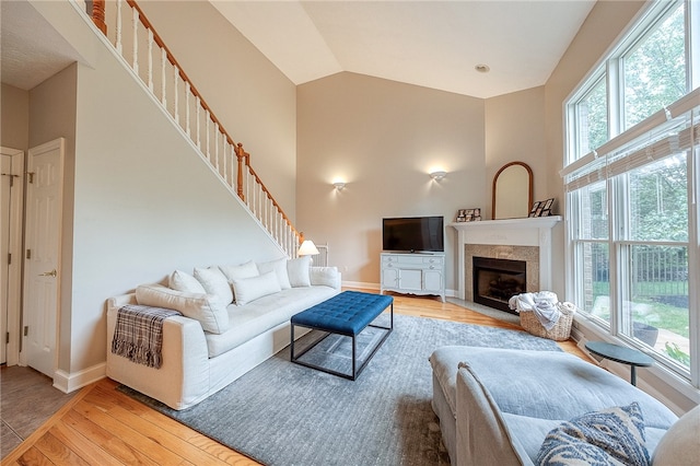 living room featuring light wood-type flooring and vaulted ceiling