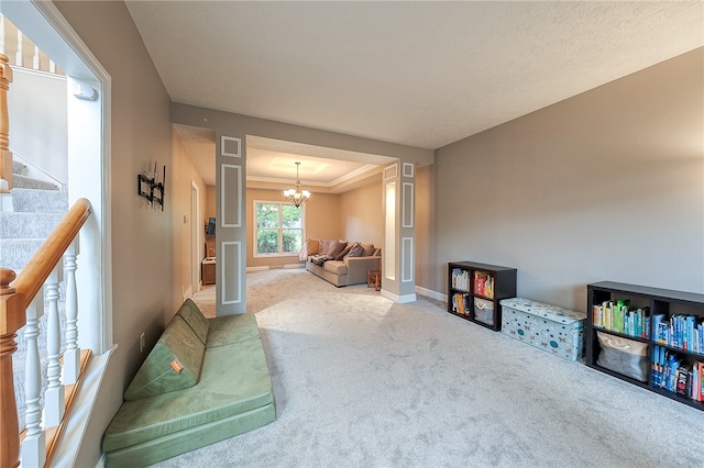 interior space with a notable chandelier, carpet, and crown molding