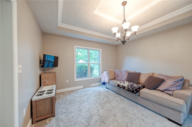 living room featuring a chandelier, a textured ceiling, light colored carpet, a raised ceiling, and ornamental molding