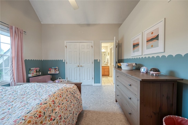 carpeted bedroom featuring vaulted ceiling, ceiling fan, and a closet