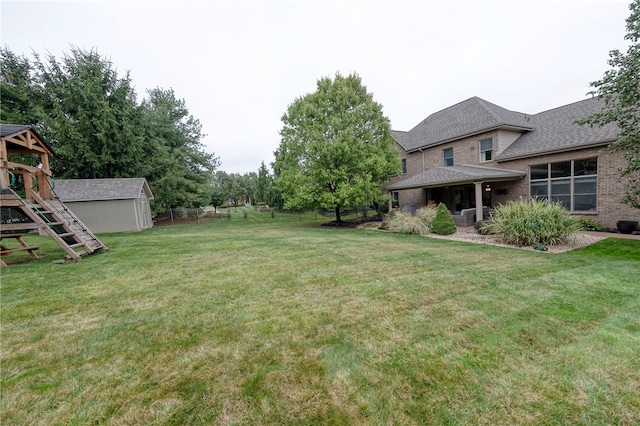 view of yard featuring a storage shed and a playground