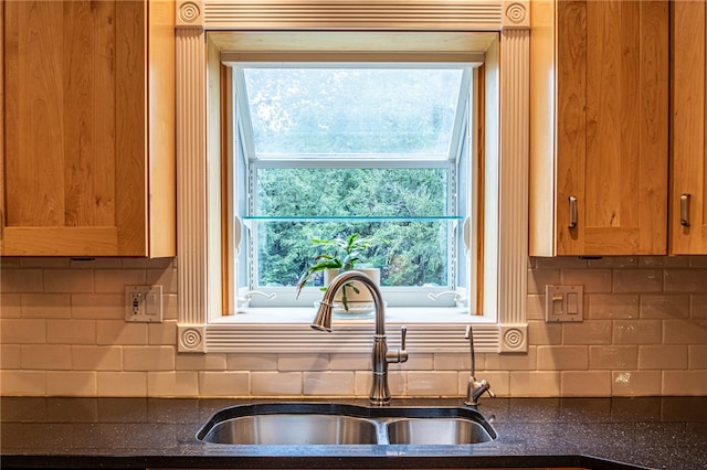 kitchen featuring backsplash and sink