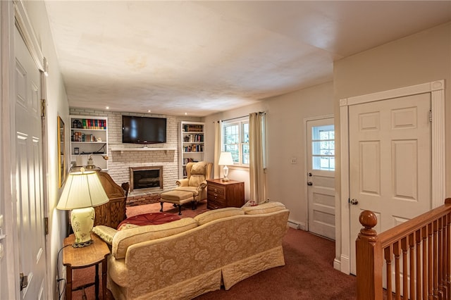 living room with carpet floors, built in features, and a brick fireplace