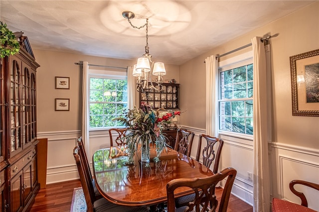 dining area featuring a notable chandelier and dark hardwood / wood-style floors