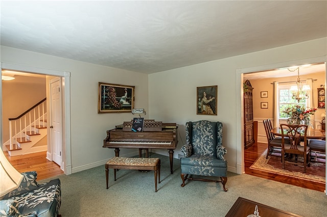 living area featuring an inviting chandelier and hardwood / wood-style flooring