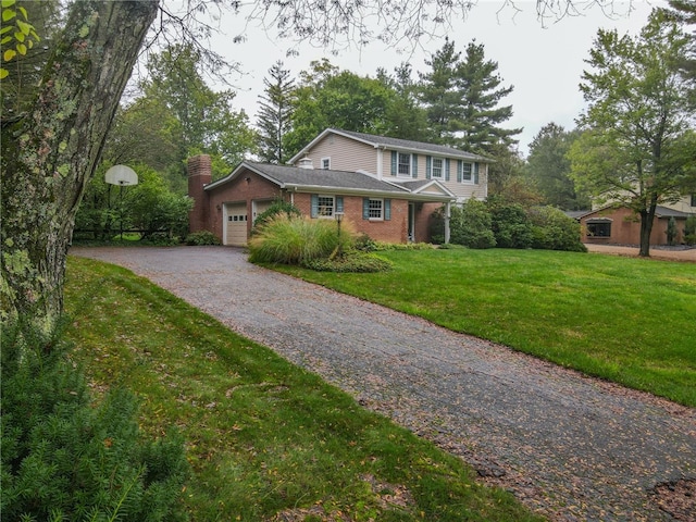 view of front facade with a garage and a front lawn