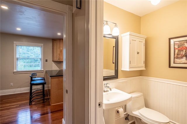 bathroom featuring hardwood / wood-style flooring, sink, and toilet