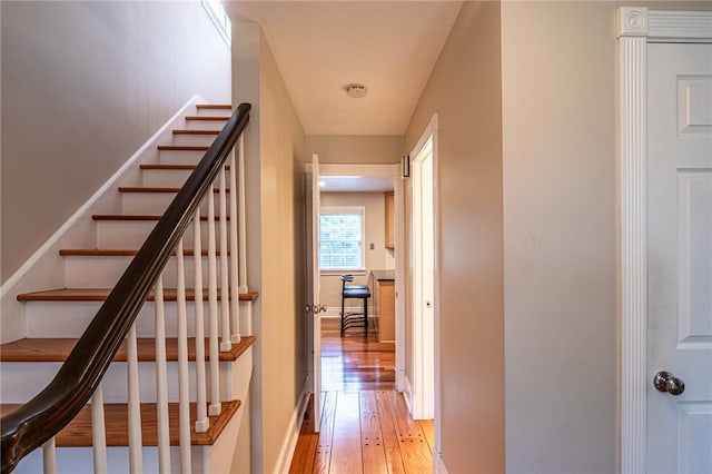 hallway with light hardwood / wood-style floors