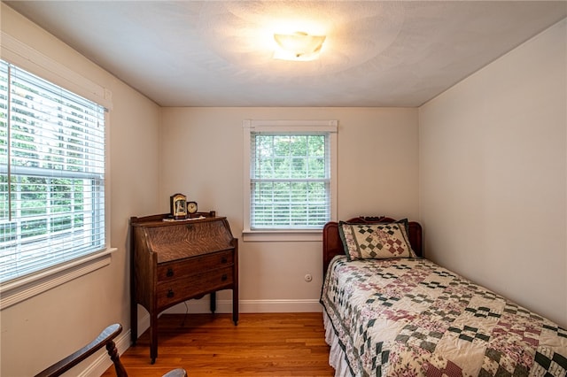 bedroom featuring light wood-type flooring and multiple windows