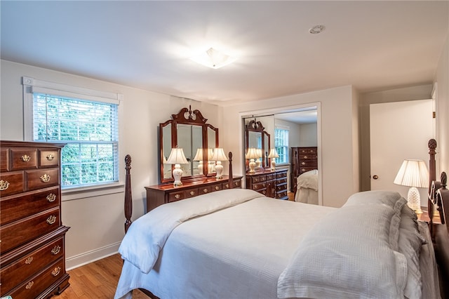 bedroom featuring light hardwood / wood-style flooring and a closet