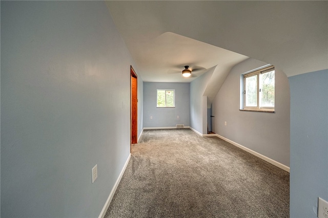 bonus room featuring lofted ceiling, carpet, ceiling fan, and plenty of natural light