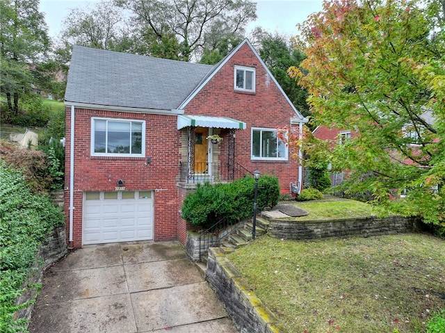 view of front of property with a garage and a front lawn