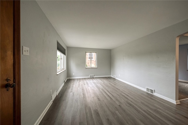 unfurnished room with dark hardwood / wood-style floors