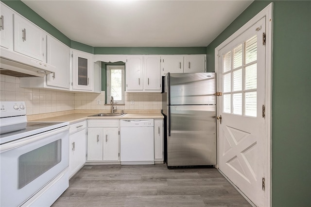 kitchen with white cabinetry, backsplash, white appliances, light wood-type flooring, and sink